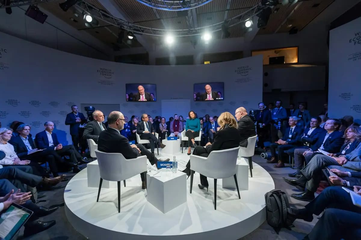 Business summit panel discussion on a round stage