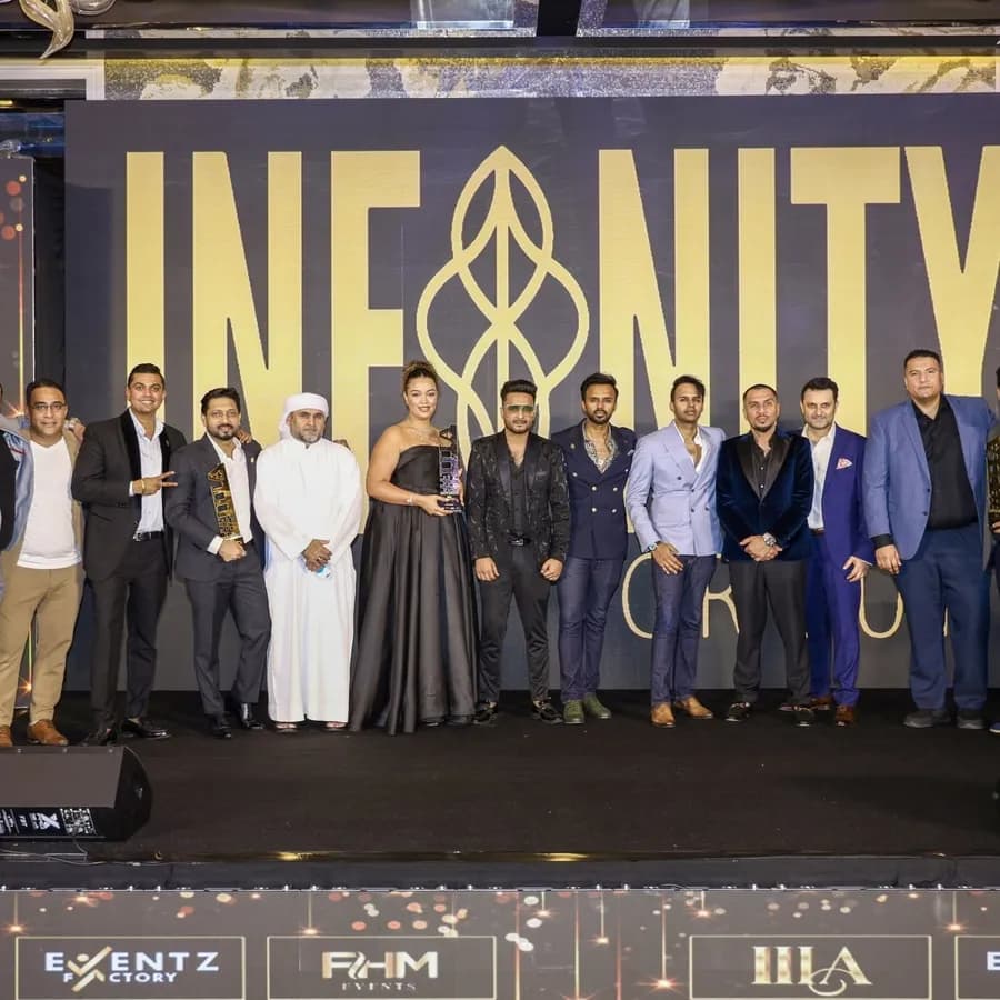 Infinity Group leadership on stage at an awards night in Dubai